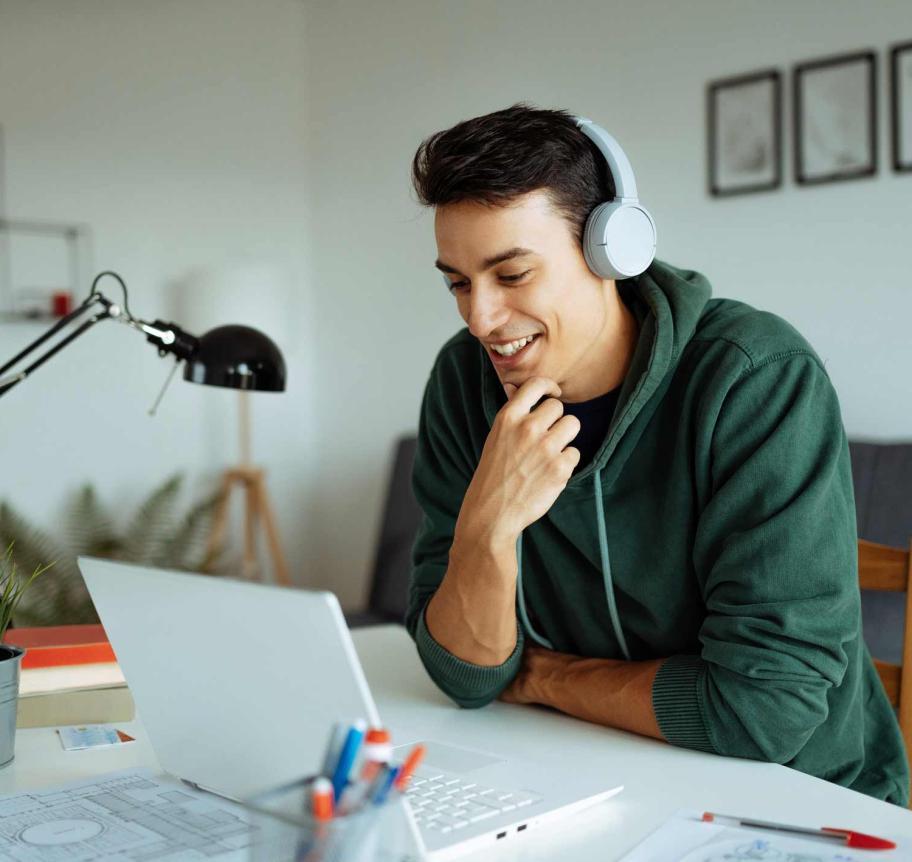 Student attending classes online at laptop